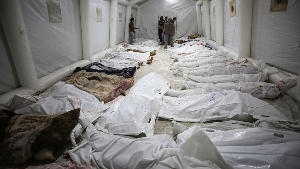 Bodies of those killed in a blast at Al-Ahli Hospital are laid out in the front yard of the Al-Shifa Hospital in Gaza City on Tuesday, October 17. - Abed Khaled/AP