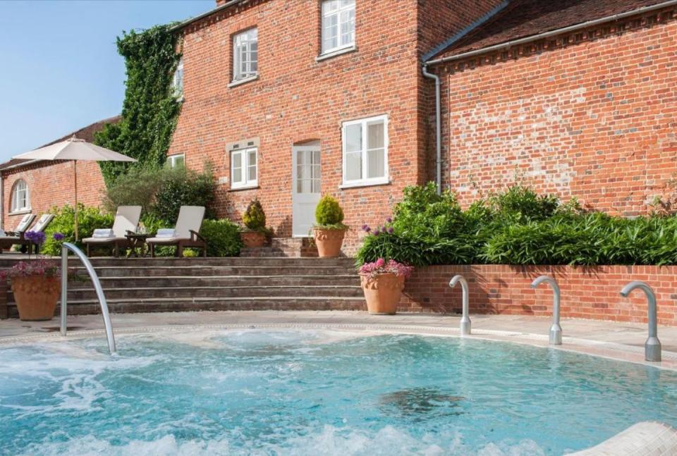 a swimming pool in front of a brick building