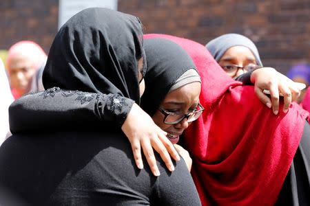 Mourners react after the funeral of Abdirahman Abdi, a mentally ill black man who died following his arrest by police, in Ottawa, Ontario, Canada, July 29, 2016. REUTERS/Chris Wattie