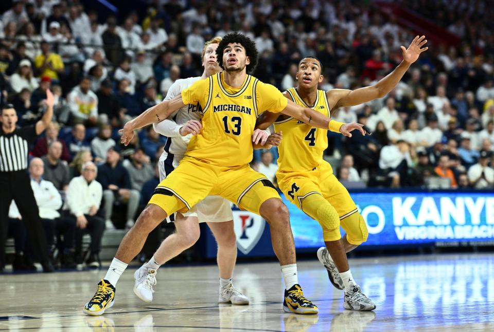 Michigan Wolverines forward Olivier Nkamhoua and guard Nimari Burnett box out Penn State Nittany Lions forward Leo O'Boyle in the first half at the Palestra on Jan. 7, 2024, in Philadelphia, Pa.