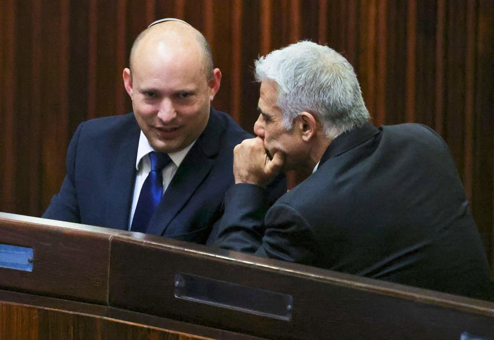 Conservative Yamina party leader Naftali Bennett talks to centrist Yesh Atid party leader Yair Lapid in Jerusalem on June 2, 2021.