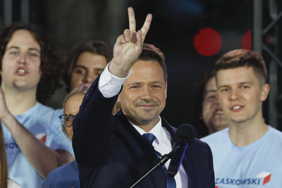 Presidential candidate Rafal Trzaskowski flashes a victory sign at the end of the election day in Warsaw, Poland, Sunday, July 12, 2020. Voting ended in Poland's razor-blade-close presidential election runoff between the conservative incumbent Andrzej Duda and liberal, pro-European Union Warsaw Mayor Rafal Trzaskowski with exit polls showing the election is too close to call. (AP Photo/Petr David Josek)