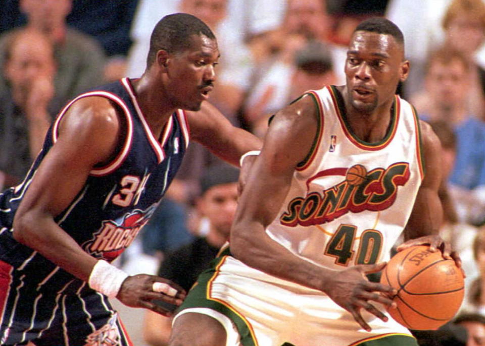 SEATTLE, WA - MAY 5:  Seattle SuperSonics' Shawn Kemp tries pass Houston Rockets' Hakeem Olajuwon during their Western Conference semi-final series game on 04 May in Seattle. Kemp finished with 17 points and 12 rebounds, while Olajuwon was held to only 6 points and 4 rebounds. The SuperSonics won 108-75.  (Photo credit should read Pete LEVINE/AFP via Getty Images)