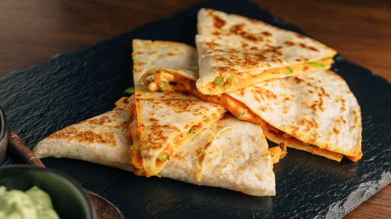 cripsy quesadillas on black platter