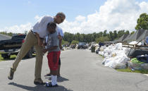 <p>President Barack Obama hugs a boy as he tours the flood-damaged Castle Place neighborhood of Baton Rouge, La., Tuesday, Aug. 23, 2016. Obama is making his first visit to flood-ravaged southern Louisiana as he attempts to assure the many thousands who have suffered damage to their homes, schools and businesses that his administration has made their recovery a priority. (AP Photo/Susan Walsh) </p>