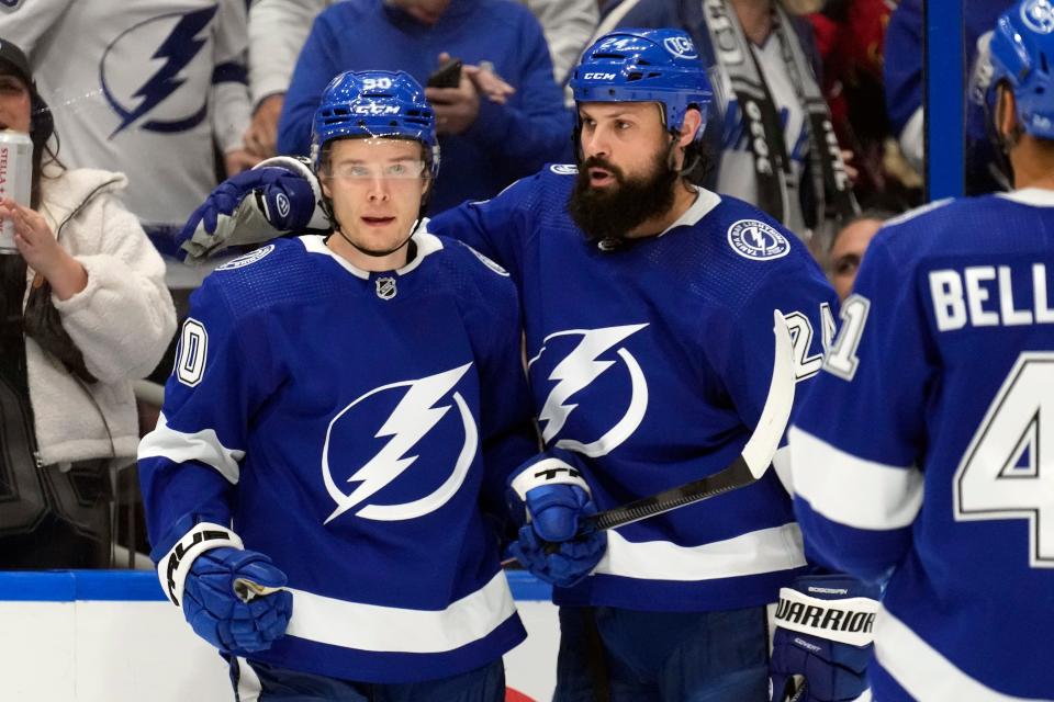 Tampa Bay Lightning center Vladislav Namestnikov (90) celebrates his goal against the Columbus Blue Jackets with defenseman Zach Bogosian (24) and left wing Pierre-Edouard Bellemare (41) during the second period of an NHL hockey game Tuesday, Jan. 10, 2023, in Tampa, Fla. (AP Photo/Chris O'Meara)