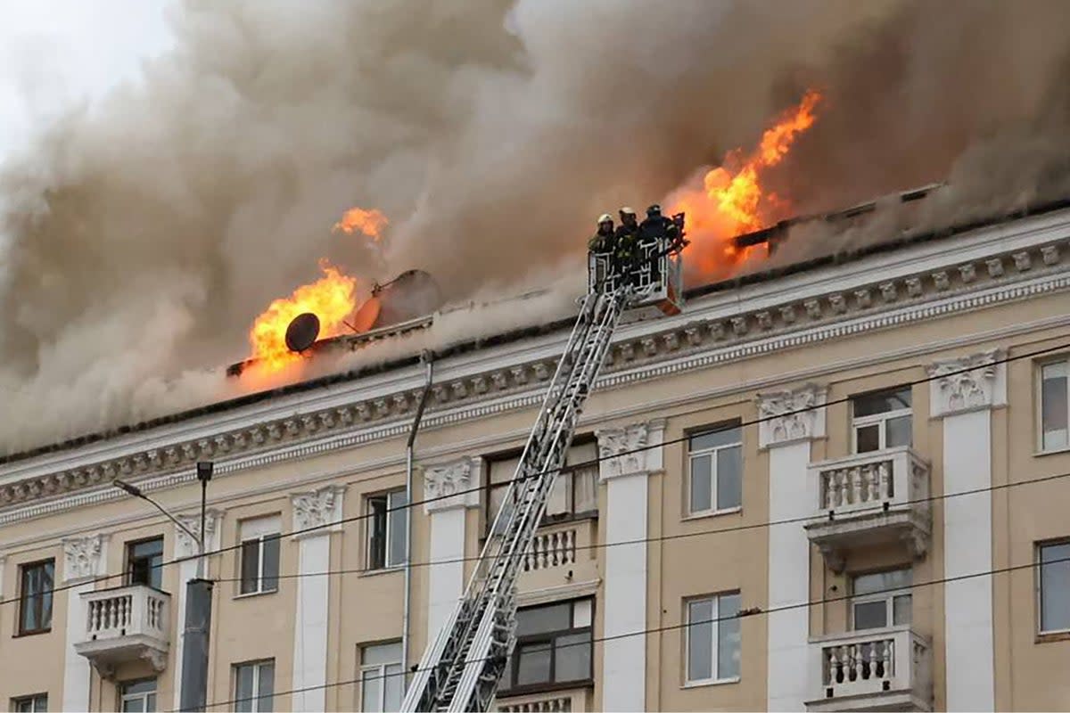 Rescuers extinguishing a fire at the site of a missile attack in Dnipro (UKRAINIAN EMERGENCY SERVICE/AFP)