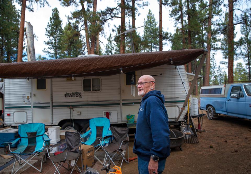 Buddy Blair visits the campsite in the forest near Sisters that he and his family call home. The couple says they make too much money to qualify for public housing assistance and not enough to pay for a market rate home in the Central Oregon tourist town.