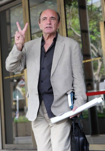 Alan Shadrake, a freelance journalist and author displays a V-sign outside the Supreme court in Singapore. Singapore's highest court ordered the defiant 76-year-old British writer to serve six weeks in jail for contempt after he published a book denouncing judicial hangings in the city-state