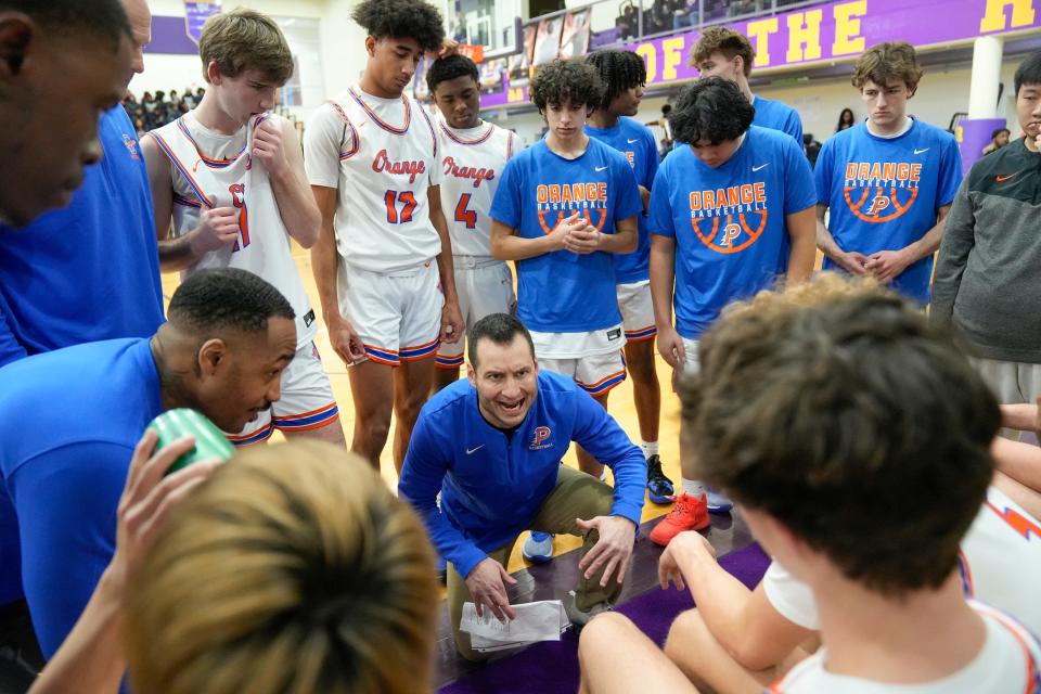 Olentangy Orange coach Anthony Calo talks to his team during a game against Walnut Ridge on Jan. 20 at Reynoldsburg.