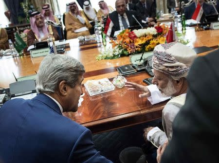 Oman's Foreign Minister Yusuf Bin Alawi bin Abdullah (R) and U.S. Secretary of State John Kerry talk before the start of a Gulf Cooperation Council and Regional Partners meeting in Jeddah September 11, 2014. REUTERS/Brendan Smialowski/Pool