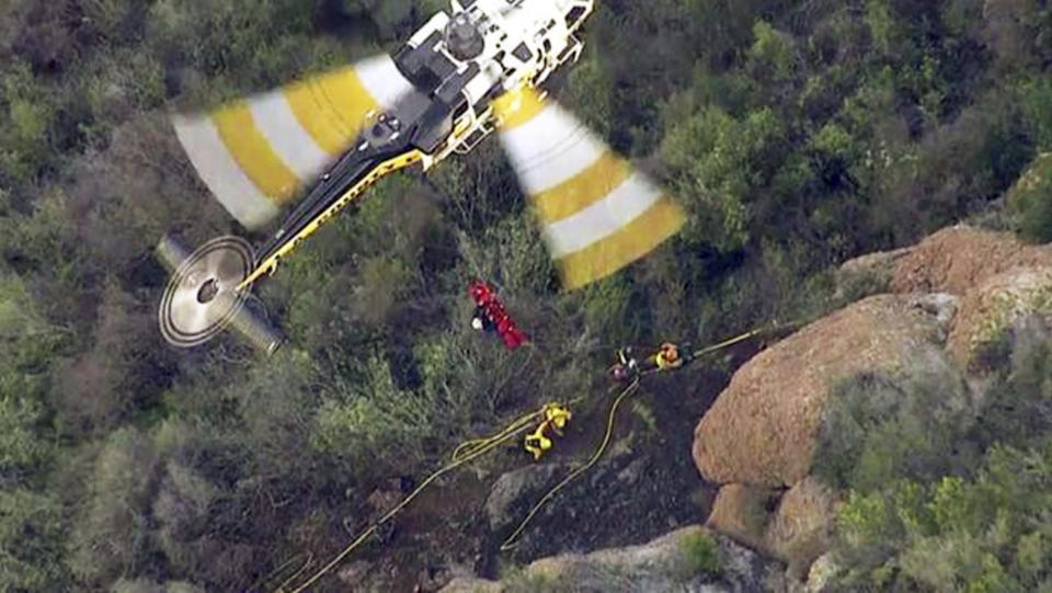 FILE - In this Feb. 25, 2016 still frame from video provided by KABC-TV, a Los Angeles County Fire Department helicopter lifts an inmate firefighter after she was injured fighting a brush fire in the Santa Monica Mountains above Malibu, Calif. California corrections officials say the firefighter, identified as Shawna Lynn Jones, died Friday, Feb. 26, a day after she was struck by a large rock while working the fire. (KABC-TV via AP) MANDATORY CREDIT TV OUT