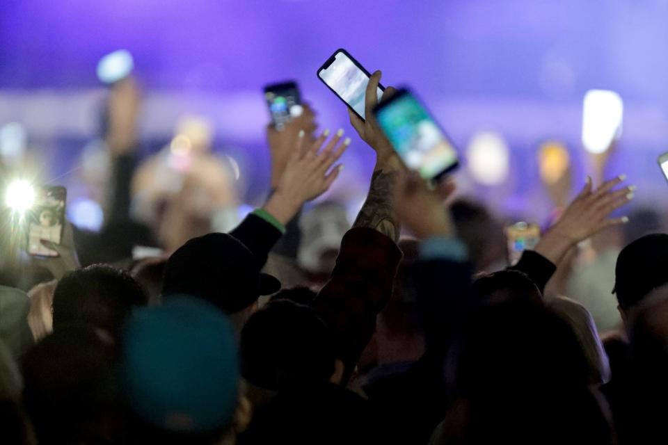 Luke Bryan fans hold their phones up prior to the concert at the PGA West Driving Range in La Quinta, Calif., on Saturday, January 18, 2020. 