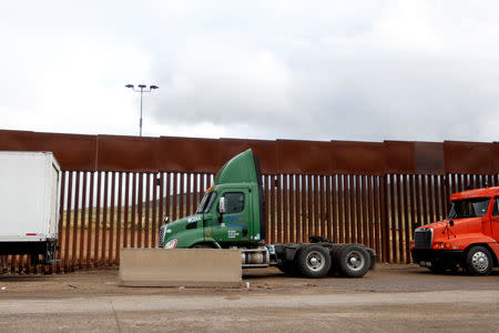 Trucks wait in a long queue at border customs control to cross into the U.S, caused by the redeployment of border officers to deal with a surge in migrants, at the Otay border crossing in Tijuana, Mexico April 3, 2019. REUTERS/Carlos Jasso