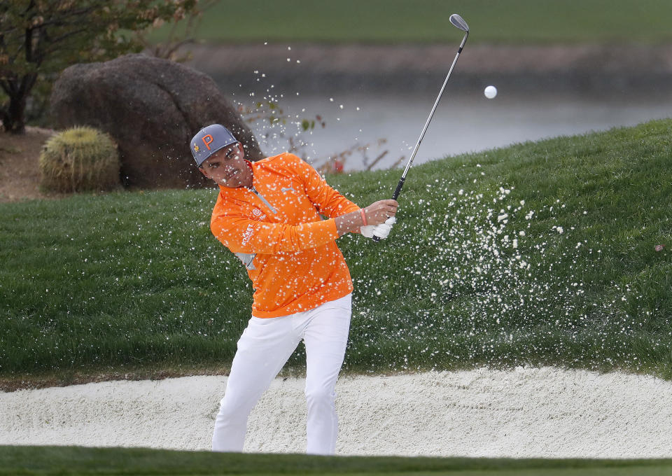 Rickie Fowler hits from the bunker on the 12th green during the final round of the Phoenix Open PGA golf tournament, Sunday, Feb. 3, 2019, in Scottsdale, Ariz. (AP Photo/Matt York)