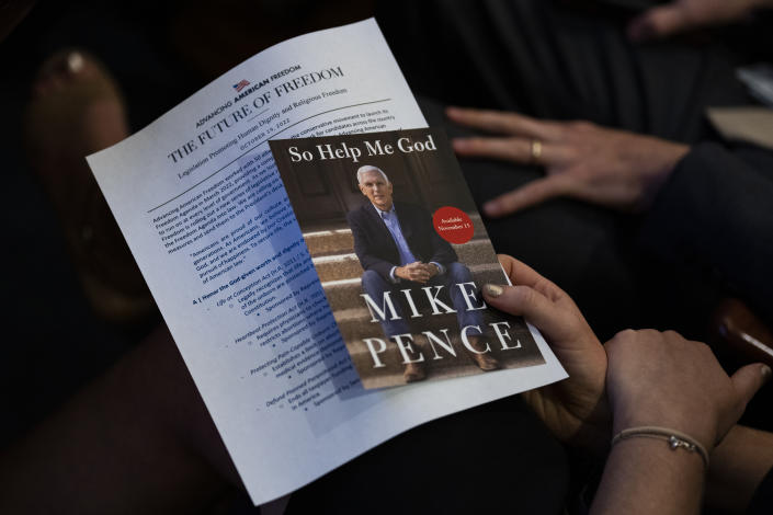 Promotional material for Pence&#39;s book in the hand of an audience member.