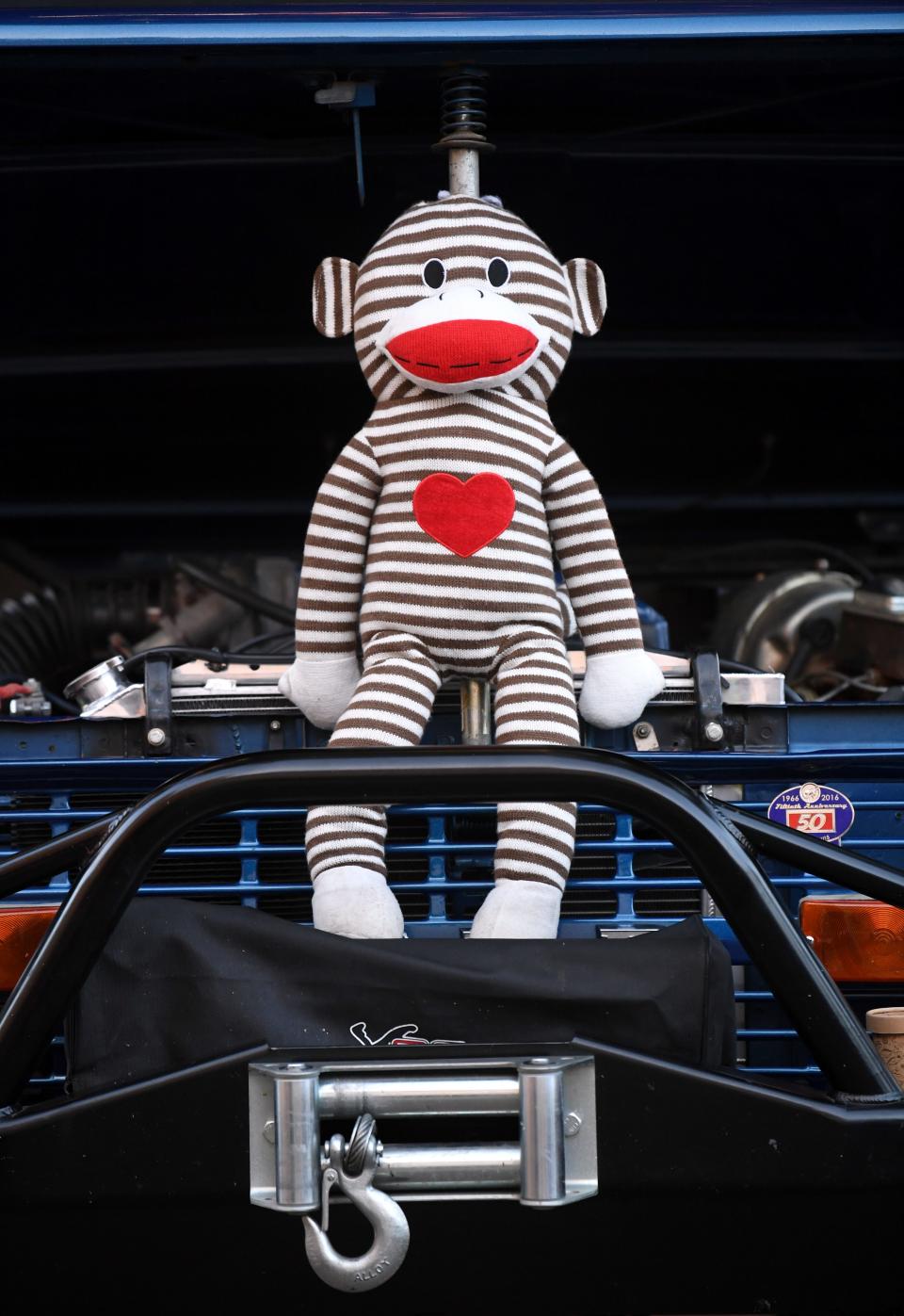 A sock monkey sits on the grill of a classic Ford Bronco during CarWalk Thursday.