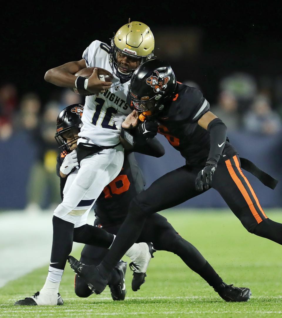 Hoban quarterback Tylan Boykin is hit by a pair of Massillon defenders in the first half.