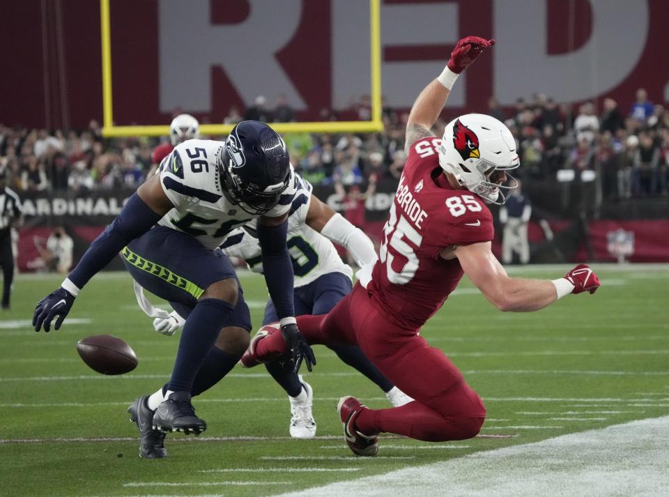 Arizona Cardinals tight end Trey McBride (85) has a pass broken up by Seattle Seahawks linebacker Jordyn Brooks (56) during the first quarter at State Farm Stadium in Glendale on Jan. 7, 2024.