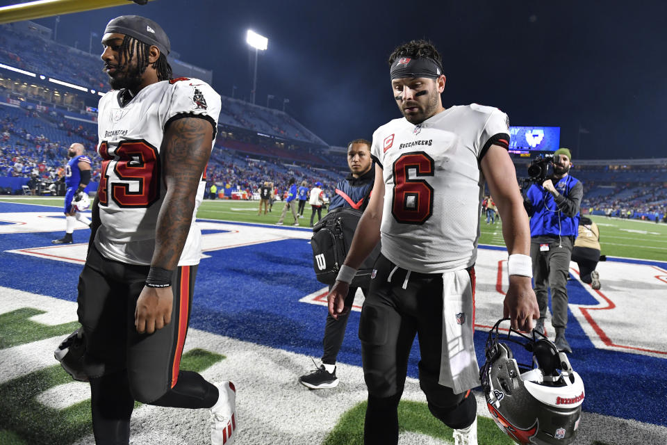 Tampa Bay Buccaneers linebacker Cam Gill, left, and quarterback Baker Mayfield (6) walk off the field after an NFL football game against the Buffalo Bills, Thursday, Oct. 26, 2023, in Orchard Park, N.Y. (AP Photo/Adrian Kraus)