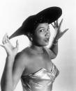 <p>Performer Pearl Bailey donning a wide-brimmed hat, tennis-style jewelry, and a sweetheart metallic gown.</p>