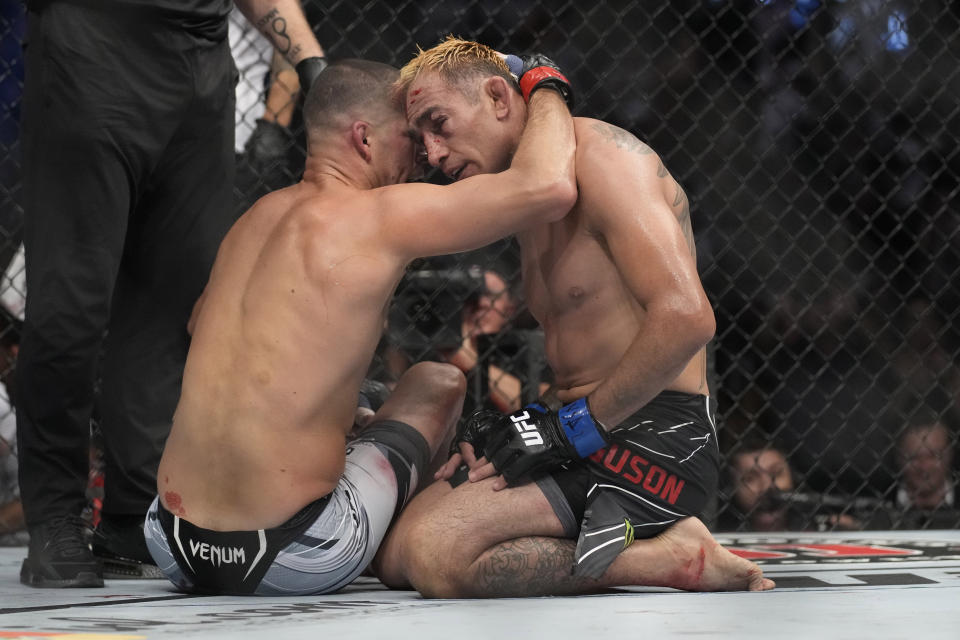 Nate Diaz, left, embraces Tony Ferguson after Diaz won their welterweight bout during the UFC 279 mixed martial arts event Saturday, Sept. 10, 2022, in Las Vegas. (AP Photo/John Locher)