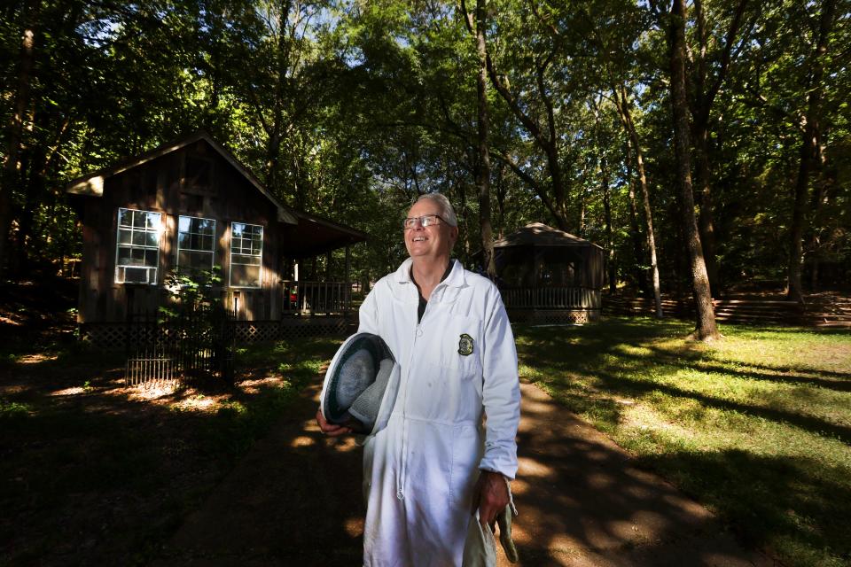 Beekeeper Mike Finnern poses for a portrait outside the apiary in the backyard of his Bartlett home on Monday, June 20, 2022. 