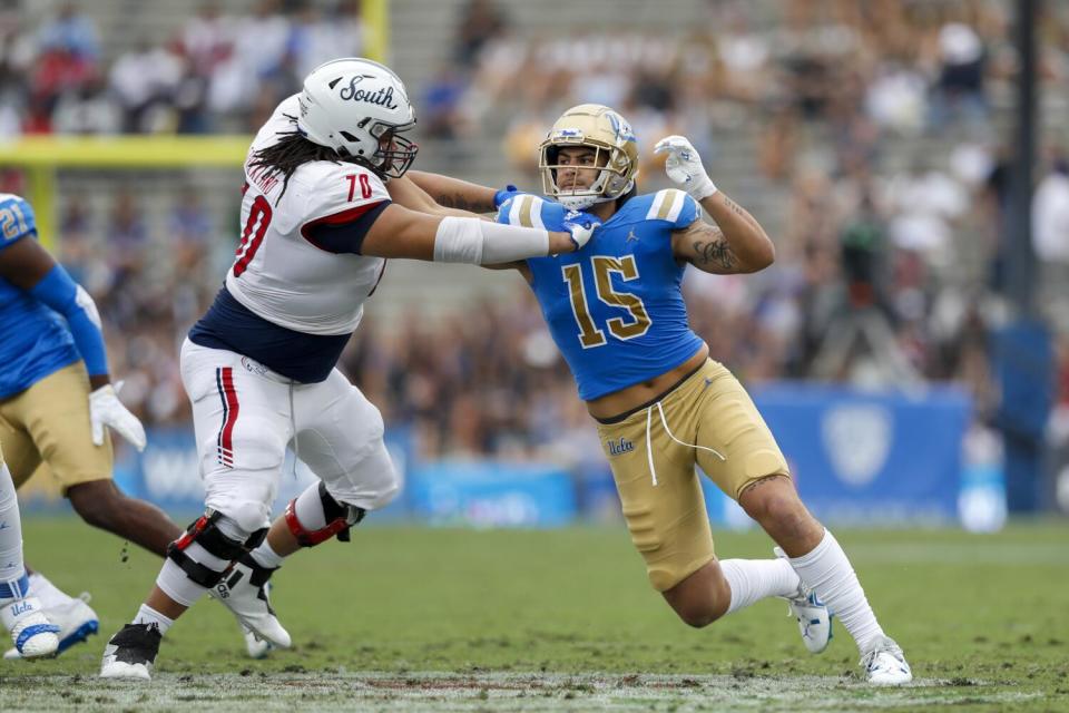 UCLA linebacker Laiatu Latu pushes against South Alabama offensive lineman Adrein Strickland