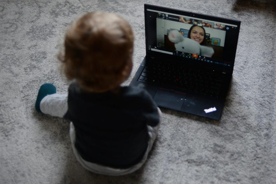 A toddler watches a live stream of circle time for babies in Toronto in March 2020. THE CANADIAN PRESS/Joe O'Connal