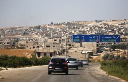 A journalists' convoy is seen at the entrance of Khan Sheikhoun, Idlib