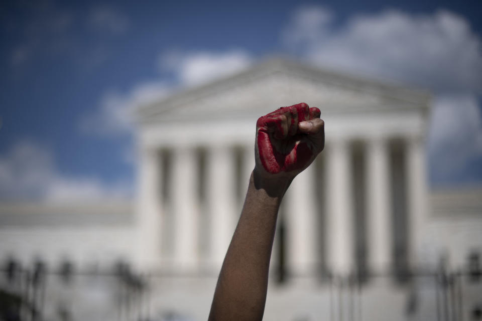 An abortion rights demonstrator raises their fist, painted in red, in the air while yelling during a rally in front of the US Supreme  Court in Washington, DC, on June 25, 2022. (Roberto Schmidt/AFP via Getty Images)