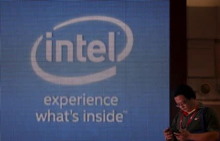 A man looks at a smartphone at the Intel booth during the 2015 Computex exhibition at the TWTC Nangang exhibition hall in Taipei, Taiwan, June 2, 2015. REUTERS/Pichi Chuang