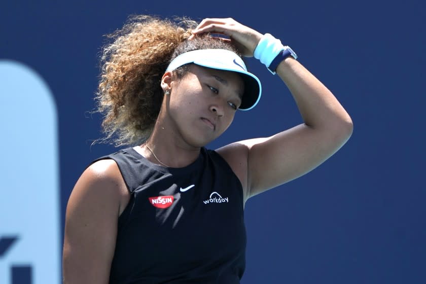 FILE - Naomi Osaka, of Japan, reacts during her match against Maria Sakkari, of Greece, in the quarterfinals of the Miami Open tennis tournament in Miami Gardens, Fla., in this Wednesday, March 31, 2021, file photo. Sakkari won 6-0, 6-4. Naomi Osaka withdrew from the French Open on Monday, May 31, 2021, and wrote on Twitter that she would be taking a break from competition, a dramatic turn of events for a four-time Grand Slam champion who said she experiences "huge waves of anxiety" before speaking to the media and revealed she has "suffered long bouts of depression."(AP Photo/Lynne Sladky, File)