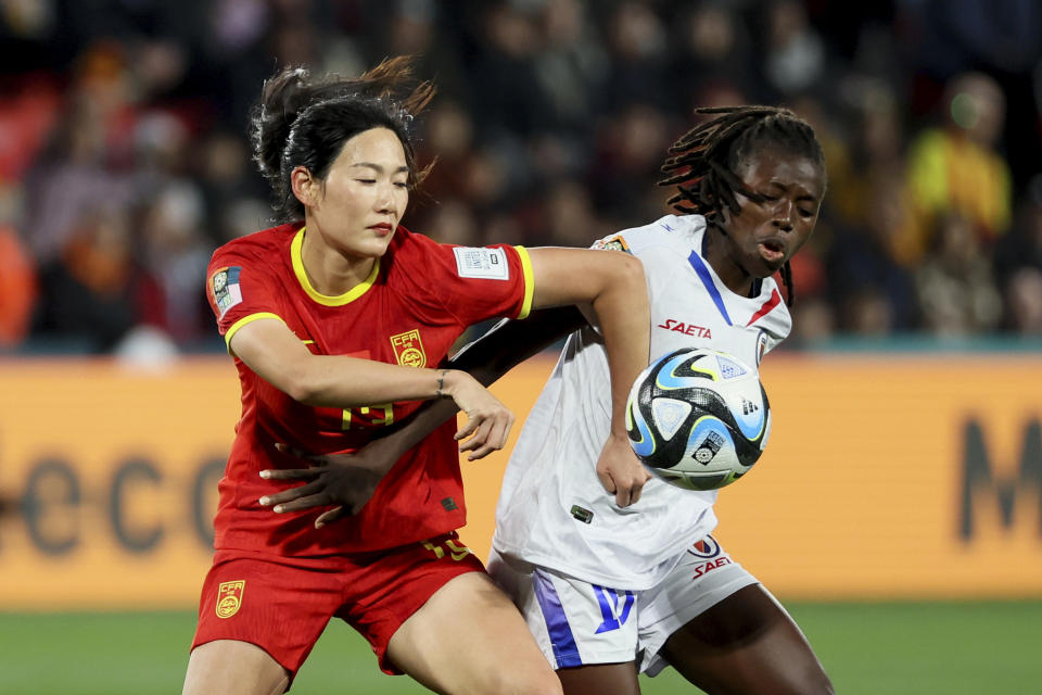 China's Yang Lina fights for the ball with Haiti's Nerilia Mondesir, right, during the Women's World Cup Group D soccer match between China and Haiti in Adelaide, Australia, Friday, July 28, 2023. (AP Photo/James Elsby)