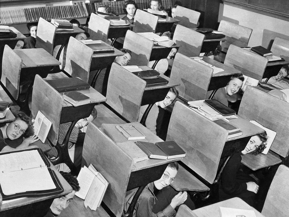 Students in a Seattle, Washington, high school ducked for shelter beneath their desks during a mock air raid in 1942.