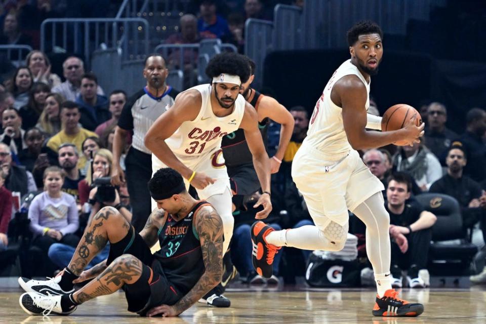 Cleveland Cavaliers' Donovan Mitchell drives near Washington Wizards' Kyle Kuzma (33) during the first half of an NBA basketball game Friday, Jan. 5, 2024, in Cleveland. (AP Photo/Nick Cammett)