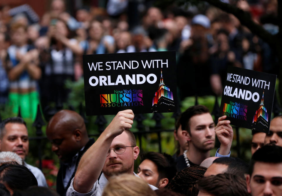 People stand during a vigil outside The Stonewall Inn remembering the victims of the Orlando massacre in New York, U.S., June 13, 2016.&nbsp;