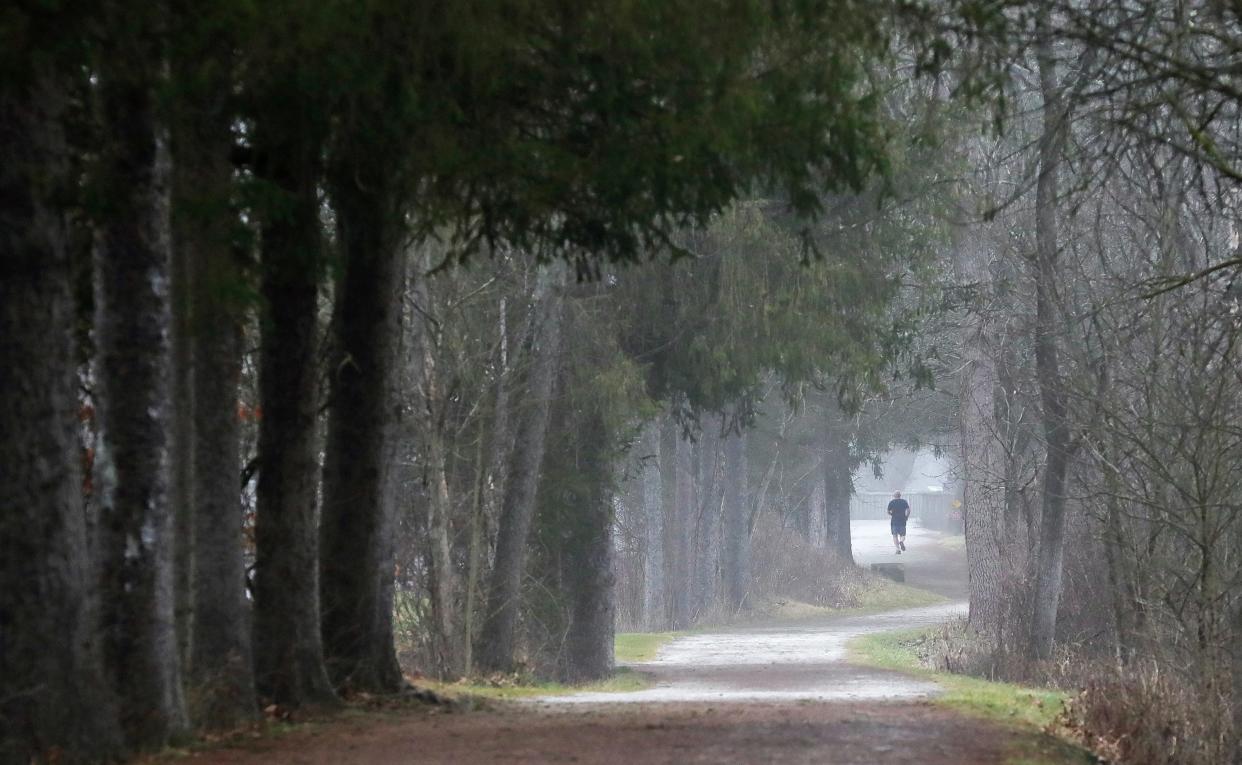 Earlier this year, a man jos on the Ohio and Erie Towpath Train in Peninsula. Dense fog could blanket parts of Greater Akron and Northeast Ohio over the next 20 hours, the National Weather Service in Cleveland said.