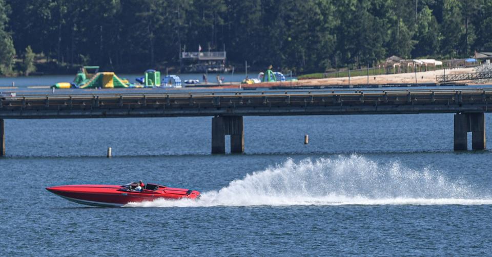 Jack Gladke of New York rides his 2008 Donzei 38DRC boat by the S.C. Highway 24 double bridges in the fun run element of the Hartwell Lake Charity Run, from Green Pond Landing to Clemson Marina, Friday, June 7, 2024.