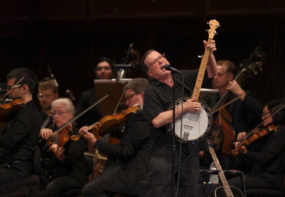 Gordon Gano of the Violent Femmes rocks out on banjo while performing with the Milwaukee Symphony Orchestra at a sold-out Bradley Symphony Center Tuesday. It was the first show of a fall tour celebrating the 40th anniversary of the Milwaukee band's debut album.