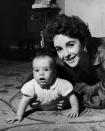 <p>Elizabeth Taylor with her son Michael Wilding Jnr. She became a mother at 21. (Photo by Keystone/Getty Images) </p>