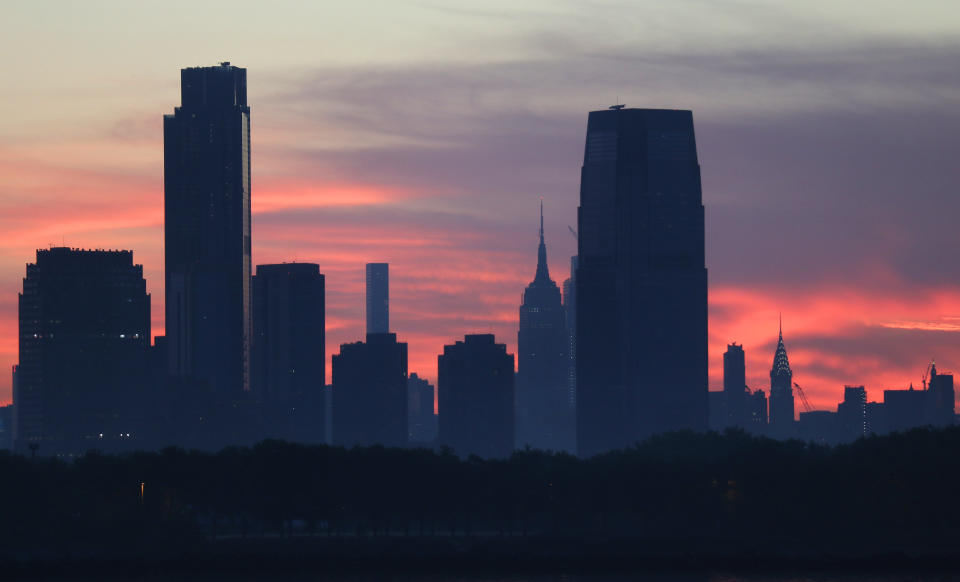 JERSEY CITY, NJ - JUNE 21: The two tallest buildings in New Jersey, 99 Hudson Street and the Goldman Sachs building stand tall over the Empire State Building and Chrysler Building in New York City as the sun rises on June 21, 2020 in Jersey City, New Jersey. (Photo by Gary Hershorn/Getty Images)