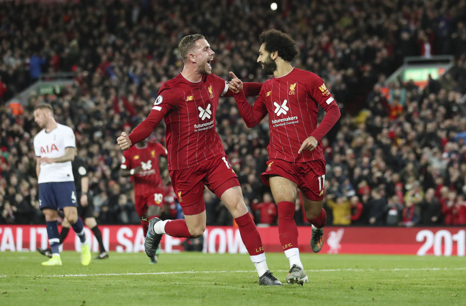 Liverpool's Mohamed Salah, right, celebrates with his teammate Jordan Henderson after scoring his side's second goal during the English Premier League soccer match between Liverpool and Tottenham Hotspur at Anfield stadium in Liverpool, England, Sunday, Oct. 27, 2019. (AP Photo/Jon Super)