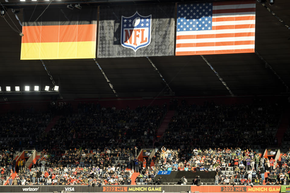FILE - The German and the United States national flags are displayed with an NFL banner over the stands of the Allianz Arena, prior to a NFL match between Tampa Bay Buccaneers and Seattle Seahawks in Munich, Germany, Sunday, Nov. 13, 2022. The NFL says there are millions of German fans who are looking for a team to support. The Chiefs go first — they’ll play the Miami Dolphins on Sunday. A week later, the Patriots face the Indianapolis Colts. Both games are at Deutsche Bank Park.(AP Photo/Markus Schreiber, File)
