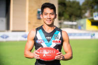 Port Adelaide Australian Rules football club's international academy recruit Chen Shaoliang from China poses with an AFL ball in Adelaide, Australia, March 21, 2017. Port Adelaide Football Club/Handout via REUTERS.