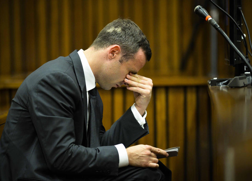 Oscar Pistorius listens to evidence in court on the fifth day of his trial at the high court in Pretoria, South Africa, Friday, March 7, 2014. Pistorius is charged with murder for the shooting death of his girlfriend, Reeva Steenkamp, on Valentines Day in 2013. (AP Photo/Theana Breugem, Pool)