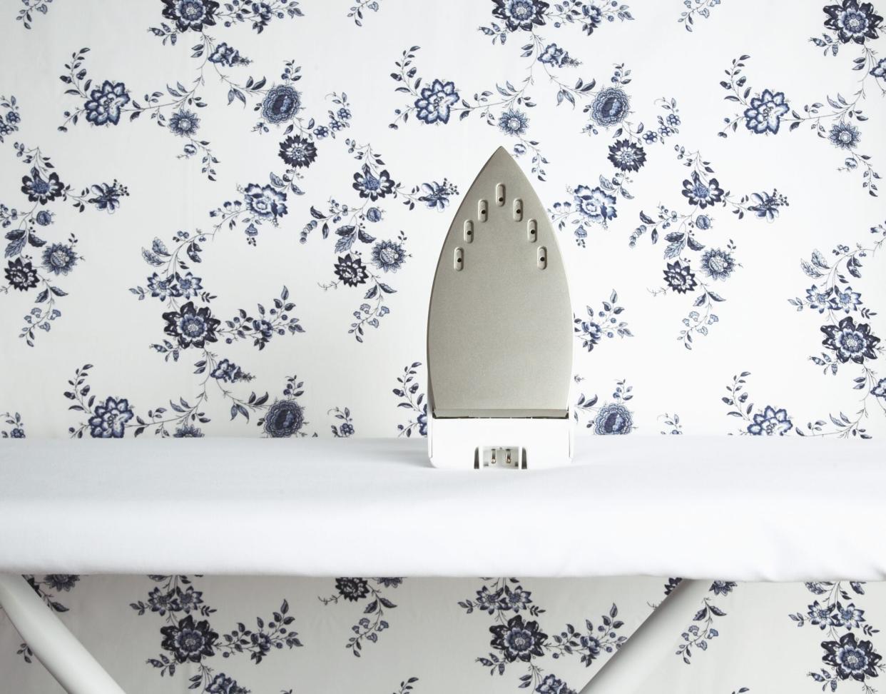 Iron on Ironing Board with Floral Background