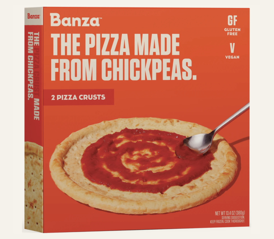 An orange pizza box with a big image of what the pizza crust looks like inside