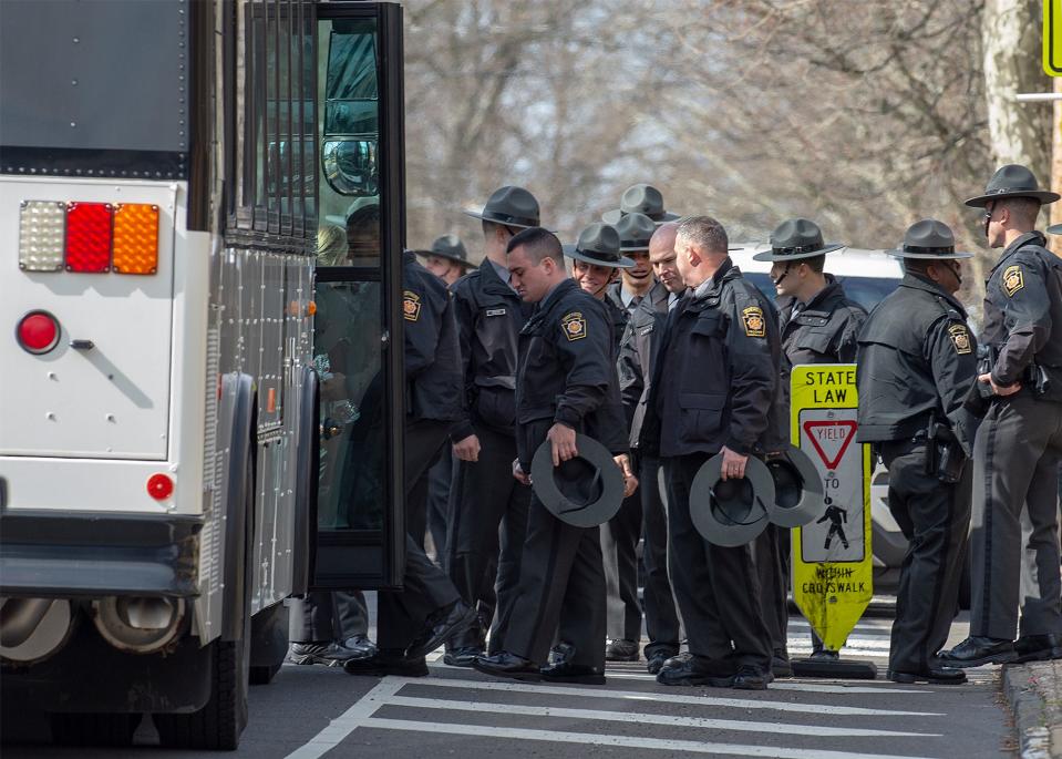 Pennsylvania State troopers start to board their buses after paying respect during the viewing of Pennsylvania State Trooper Martin Mack III, held at the Wade Funeral Home in Bristol Borough, on Wednesday, March 30, 2022.