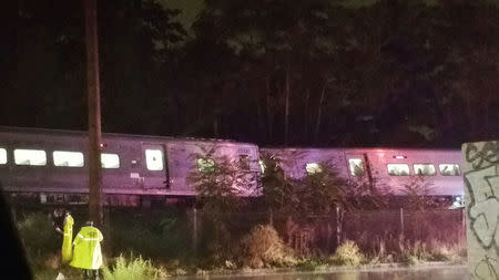 A train sits derailed near the community of New Hyde Park on Long Island in New York, U.S., October 8, 2016. Sarah Qamar/Handout via REUTERS